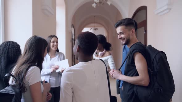 Group of Uni Friends Laughing, Talking in University