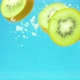 slices of kiwi fruit splash into water in slow motion - VideoHive Item for Sale