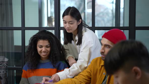 Focused Diverse Designers at Brainstorming Meeting