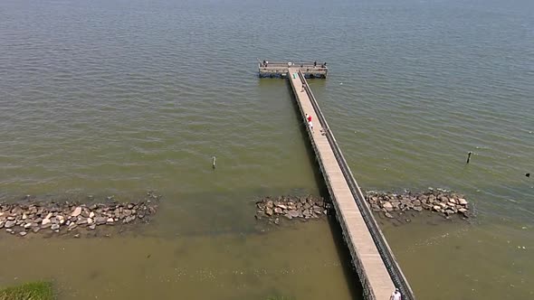 Aerial shot of fishing pier and breakwater.