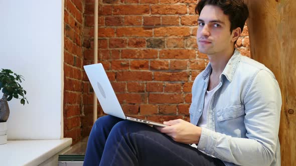 No, Young Man Shaking Head to Deny, Working on Computer