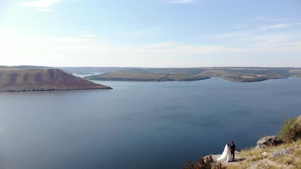 Amazing Aerial View on the Dniester Canyon, River and Bakota Bay. Couple Walking on Mountains. 