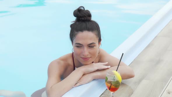 Beautiful Young Woman Relaxing After Swimming in the Pool