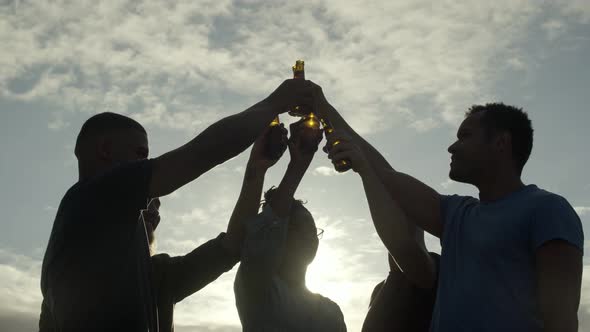 Smiling Friends Cheering with Beer Bottles and Talking