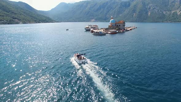 Boat Sails on the Sea Past the Island of Gospa Od Skrpjela