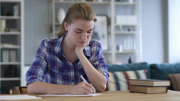 Tired Young Woman Writing on Paper and Sleeping