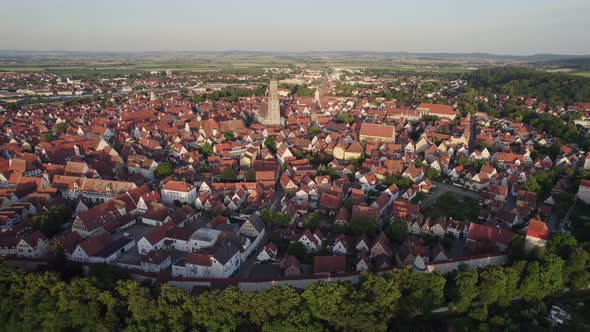 Aerial orbit of historical Nordlingen town centre at sunset, Bavaria Germany