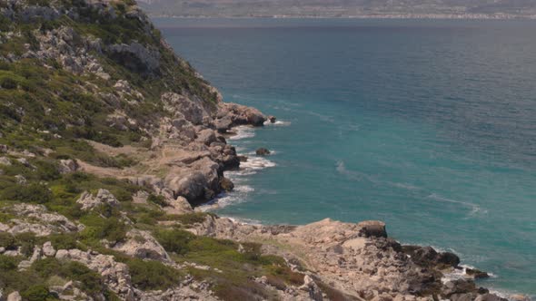 Aerial Tilt Down from Lighthouse Near Loutraki to Cliffs on the Blue Ionian Sea