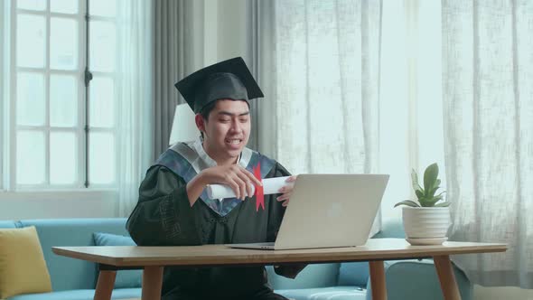 Excited Man Showing Off A University Certificate To The Family During An Online Video Call At Home