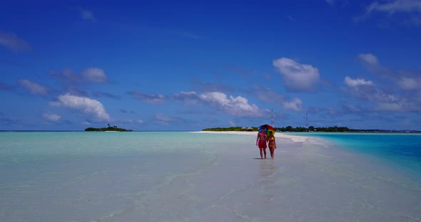 Happy couple on honeymoon vacation live the dream on beach on white sand 4K background