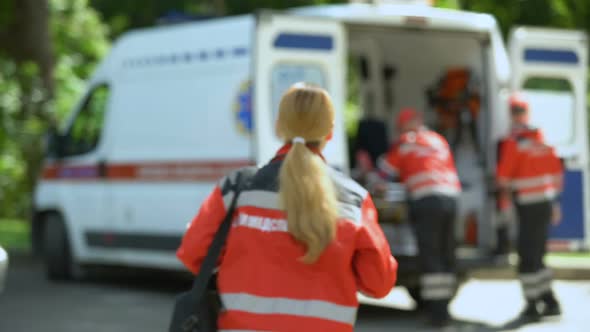 Paramedic Looks at Camera, Getting Into Ambulance, Patient's Transportation