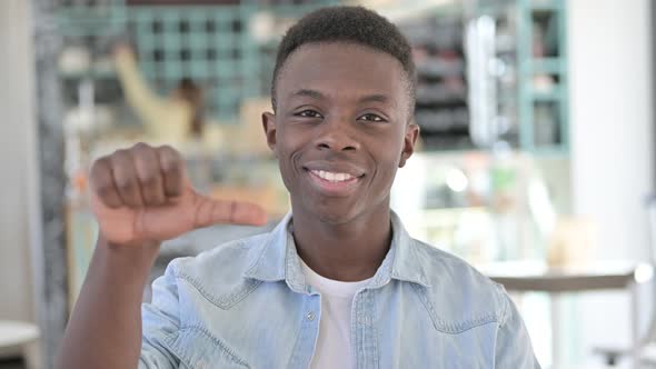 Disappointed African Man doing Thumbs Down
