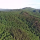Take-off camera up near a mountain with dense green forest. Taiga forest zone in summer. - VideoHive Item for Sale