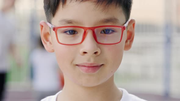 Close Up Portrait of Little Asian Schoolboy in Glasses