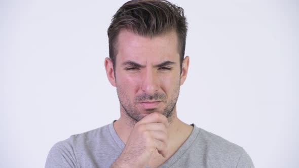 Young Serious Hispanic Man Thinking While Looking Down