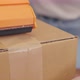 Close up shot of Young Asian Woman Hand Packing, Taping a Cardboard Box - VideoHive Item for Sale