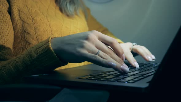 Close Up of Female Hands with a Rings Typing on a Laptop