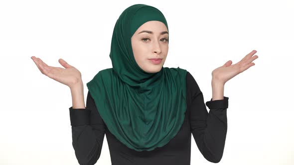 Portrait of Pretty Woman in Religious Niqab Throwing Up Hands Meaning Have No Idea or Not My