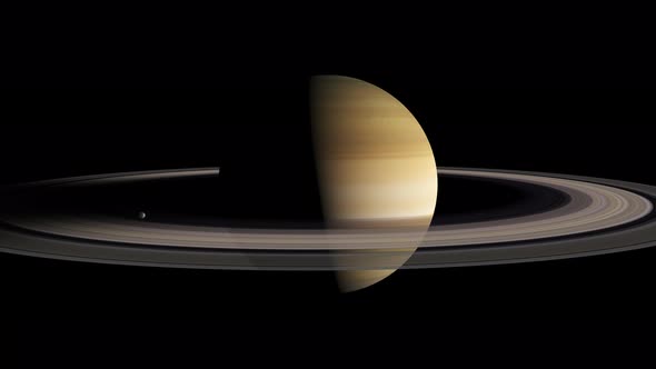 Saturn half lit with the rings in shadow