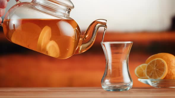 Pouring Citrus Black Tea Into Armudu Glass Closeup