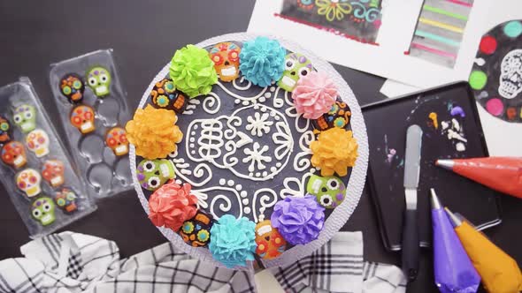 Time lapse. Step by step. Flat lay. Baker decorating multilayer chocolate cake with colorful italian