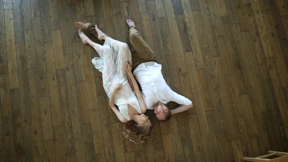 beautiful man with woman lie on the floor top view