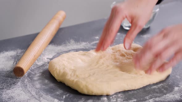 Woman Rolling Out the Dough for Buns