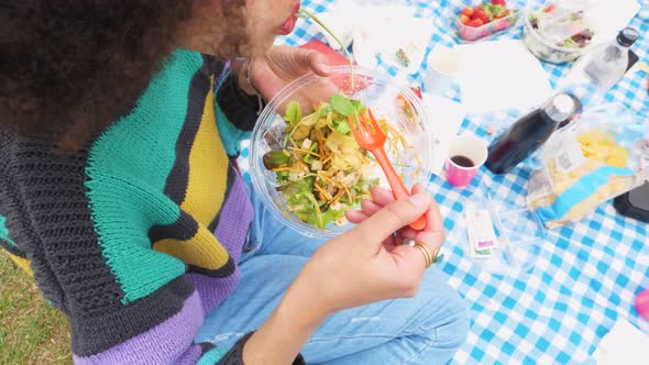 Slow motion close up vegan young woman on a diet having pic nic in a park