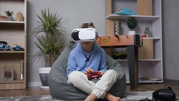 Boy which Sitting on Chair-Bag and Enjoying Video Games Using Virtual Reality Headset