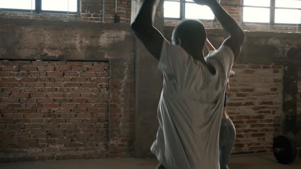 Fitness. Fit couple doing jumping jack exercise at gym indoors