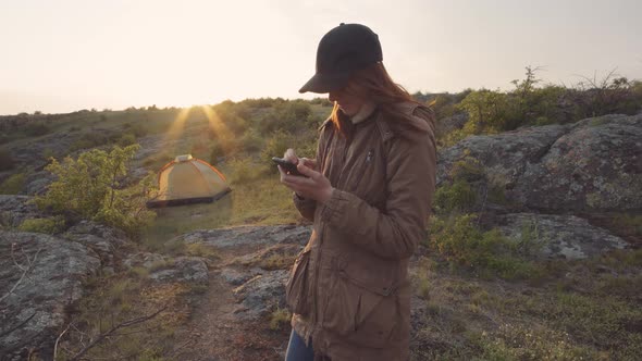 A Young Woman Traveler Walks in the Mountains at Canyon