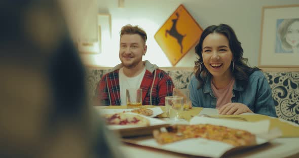 Friends Laugh at the Table and Talk