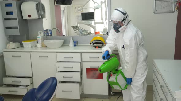 A Nurse in a Protective Suit Sterilizing the Clinic.