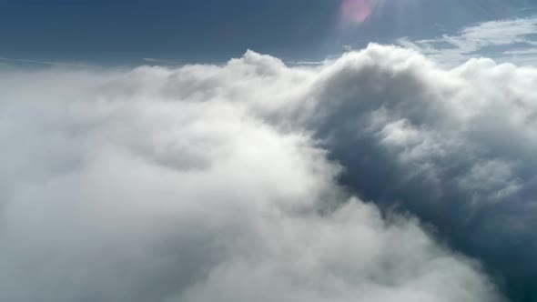 Flying Over the Thick Clouds During the Sunset. Aerial Shot of Evening Skies.