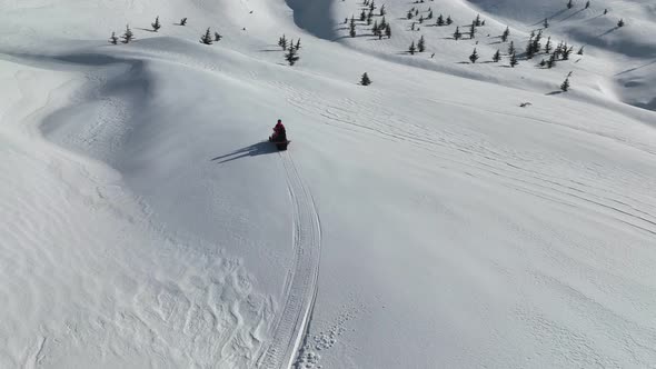 Snowmobile high in the mountains aerial view 4 K