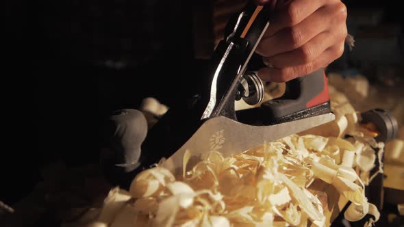 Placing hand plane down on shavings dramatic wind impact Slow motion