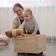 Little baby boy with mother collecting toys in wooden toy box - VideoHive Item for Sale