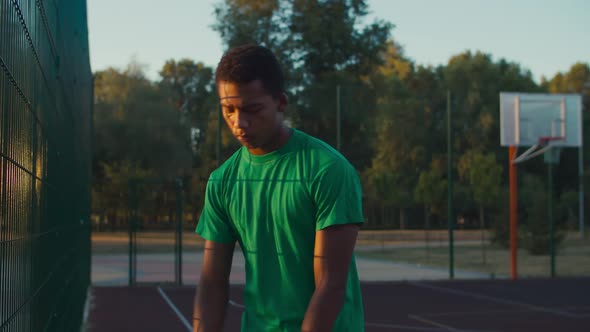 Basketball Player Dribbling Ball Outdoor at Dawn