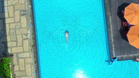 Young Woman Relaxing in the Pool