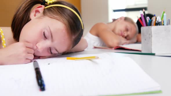 School kids sleeping on desk in classroom