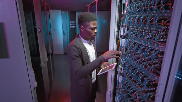 African-American Male Technician Working in Data Center