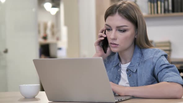 Young Girl Talking on Phone and Discussing Progress