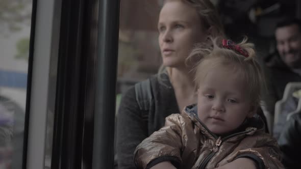 Baby girl on mums lap in the bus