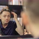 Man Straightens His Hair Looking in the Mirror in a Barbershop - VideoHive Item for Sale