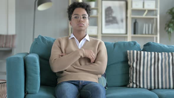 African Girl Thinking While Sitting on Couch