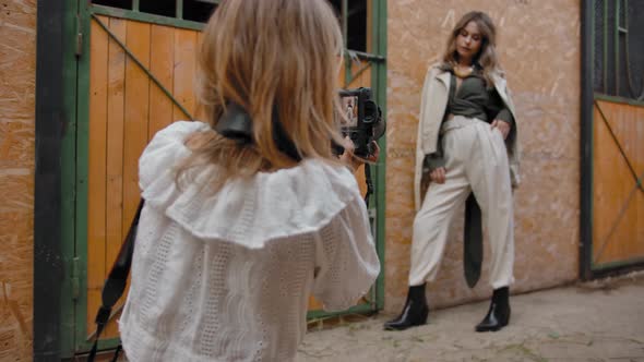 Photographer and Model During Photoshoot in Barn