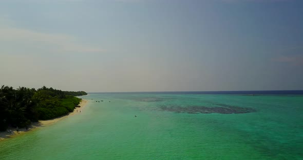 Luxury overhead tourism shot of a sunshine white sandy paradise beach and aqua blue ocean background