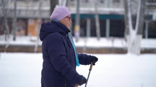 Active Senior Elderly Woman Training Nordic Walking with Trekking Poles. Elderly Woman Practicing