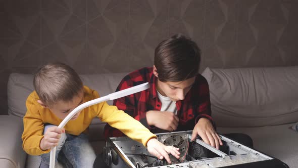 Curious Child Asks the Older Brother What Is in the Computer