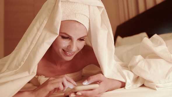 Woman Use of Mobile Phone and Read on Cellphone at Night